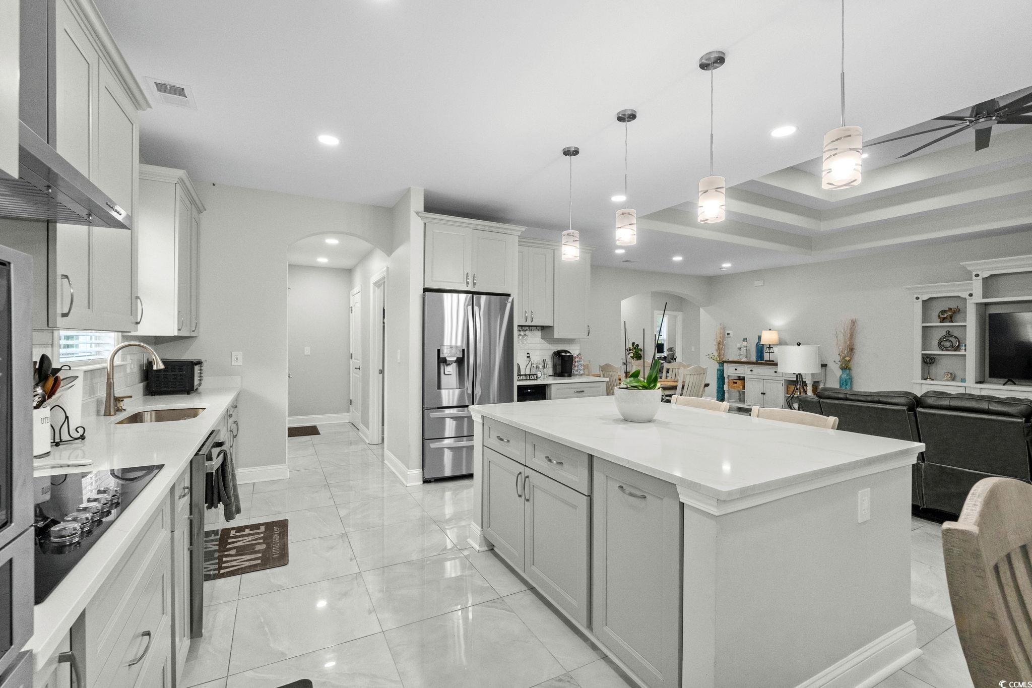 2133 Carries Lane Road Longs, SC 29568 - Photo 40 of 40 Kitchen with arched walkways, stainless steel fridge with ice dispenser, light countertops, open floor plan, and black electric stovetop