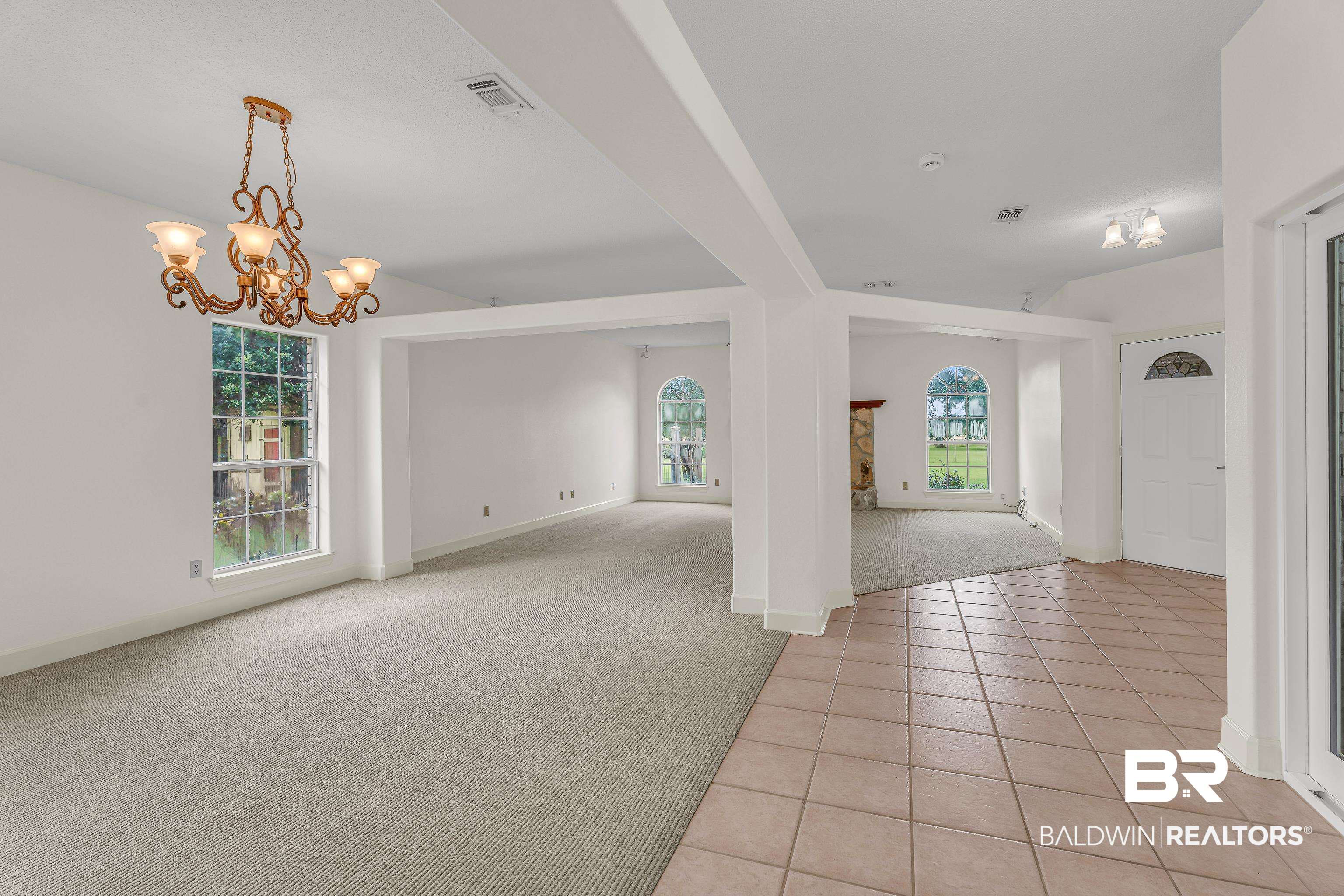 9530 Pilgrim Drive Elberta, AL 36530 - Photo 3 of 61 Interior space with light carpet, a chandelier, baseboards, light tile patterned floors, and visible vents