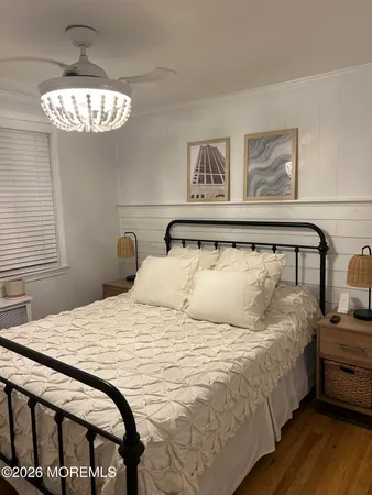 a bedroom with a bed and a chandelier