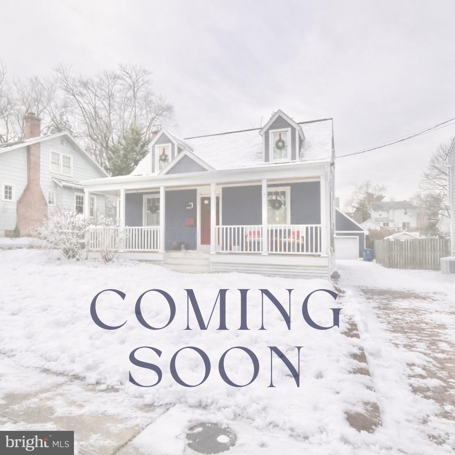 a view of a white house with a large tree in front of it
