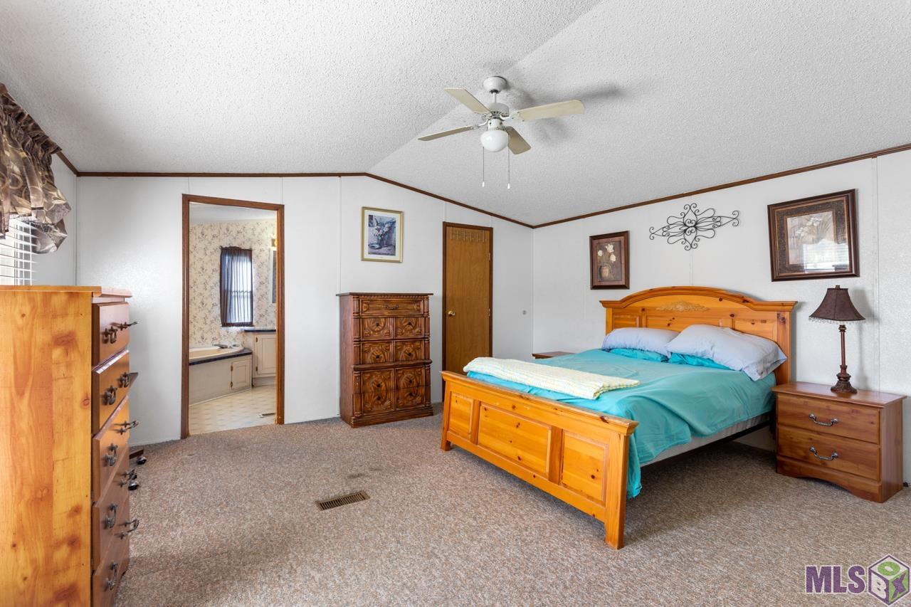 21149 Chaney Road Zachary, LA 70791 - Photo 10 of 13 Spacious Master Bedroom with a Private Bath & Walk-in Closet
