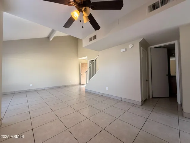 a bathroom with a granite countertop toilet and a sink