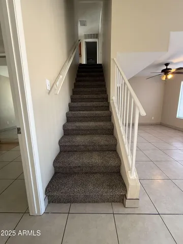 a bathroom with a granite countertop sink and a toilet