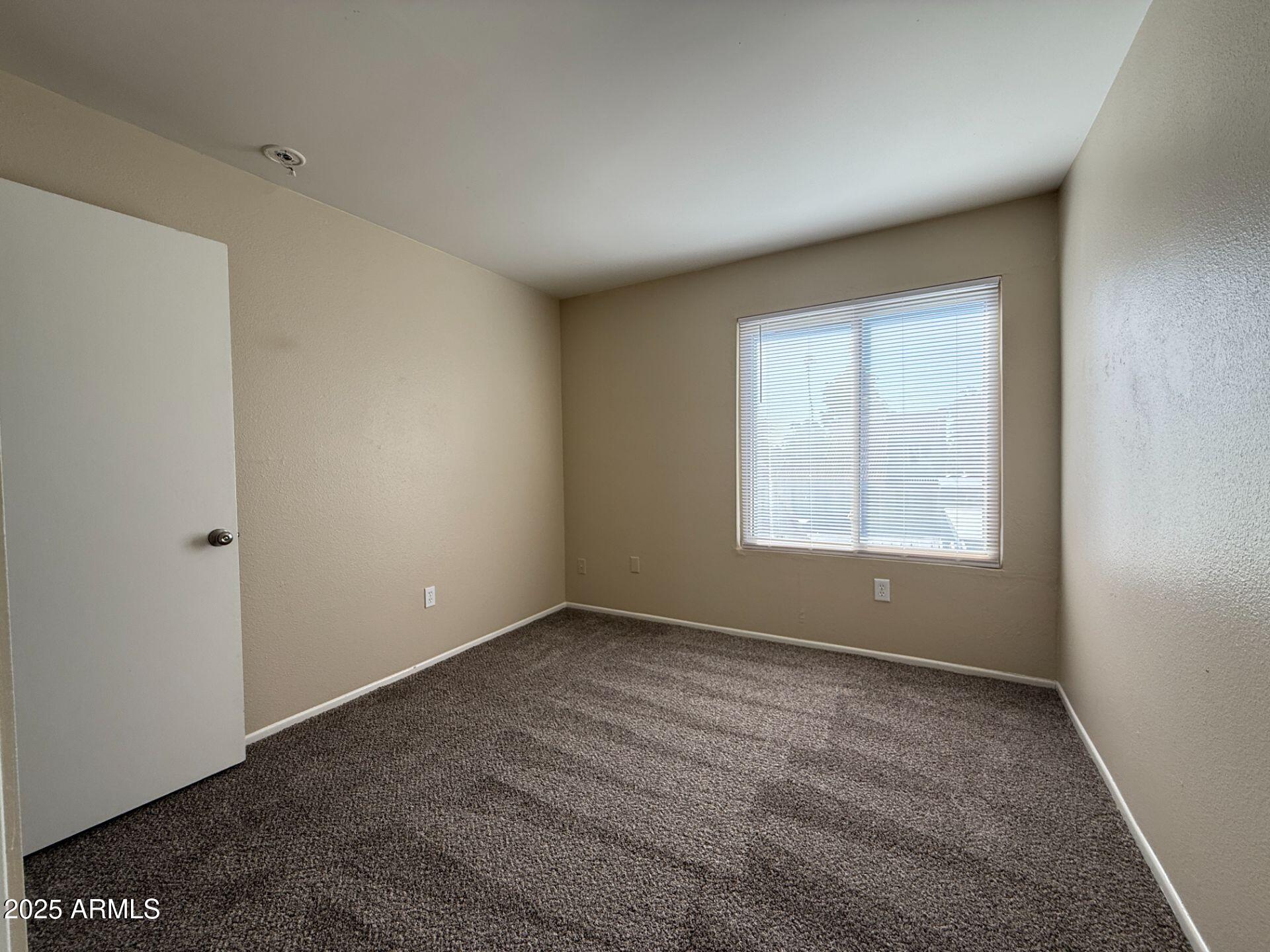 2415 West Greenway Road, Unit 3 Phoenix, AZ 85023 - Photo 17 of 36 a view of an empty room with a window