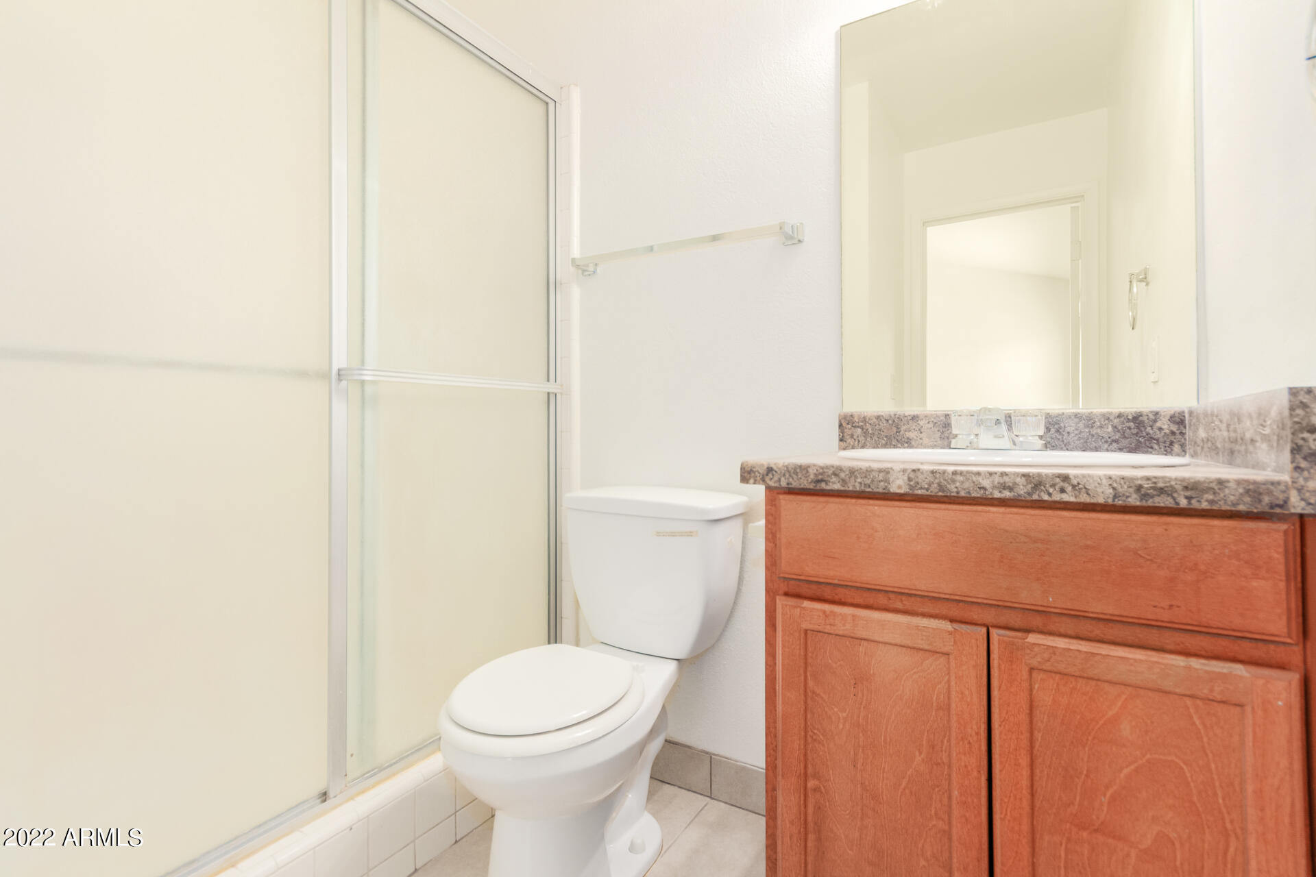 2415 West Greenway Road, Unit 3 Phoenix, AZ 85023 - Photo 20 of 36 a bathroom with a granite countertop sink and a toilet
