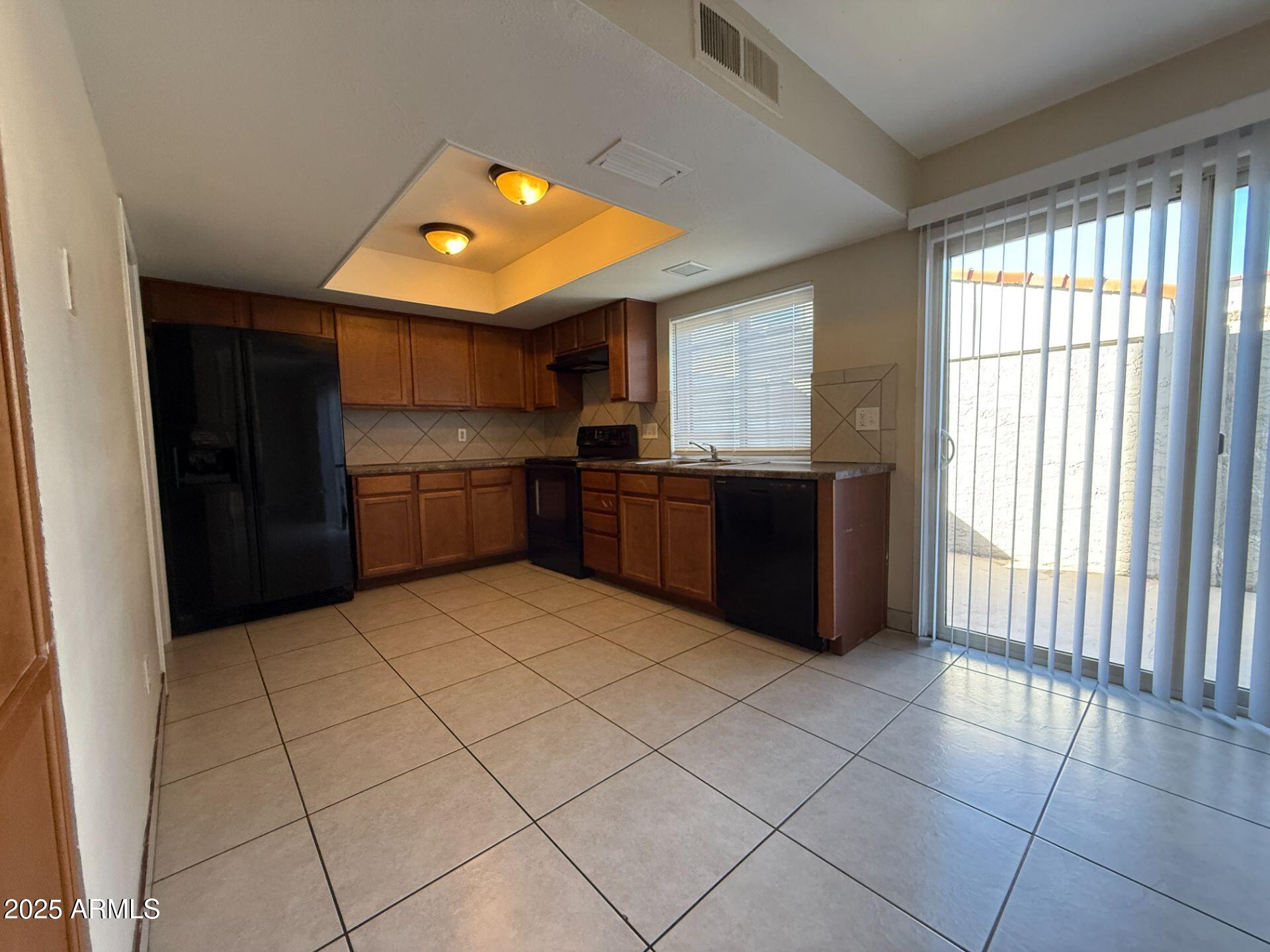 2415 West Greenway Road, Unit 3 Phoenix, AZ 85023 - Photo 9 of 36 a kitchen with stainless steel appliances granite countertop a refrigerator and a sink