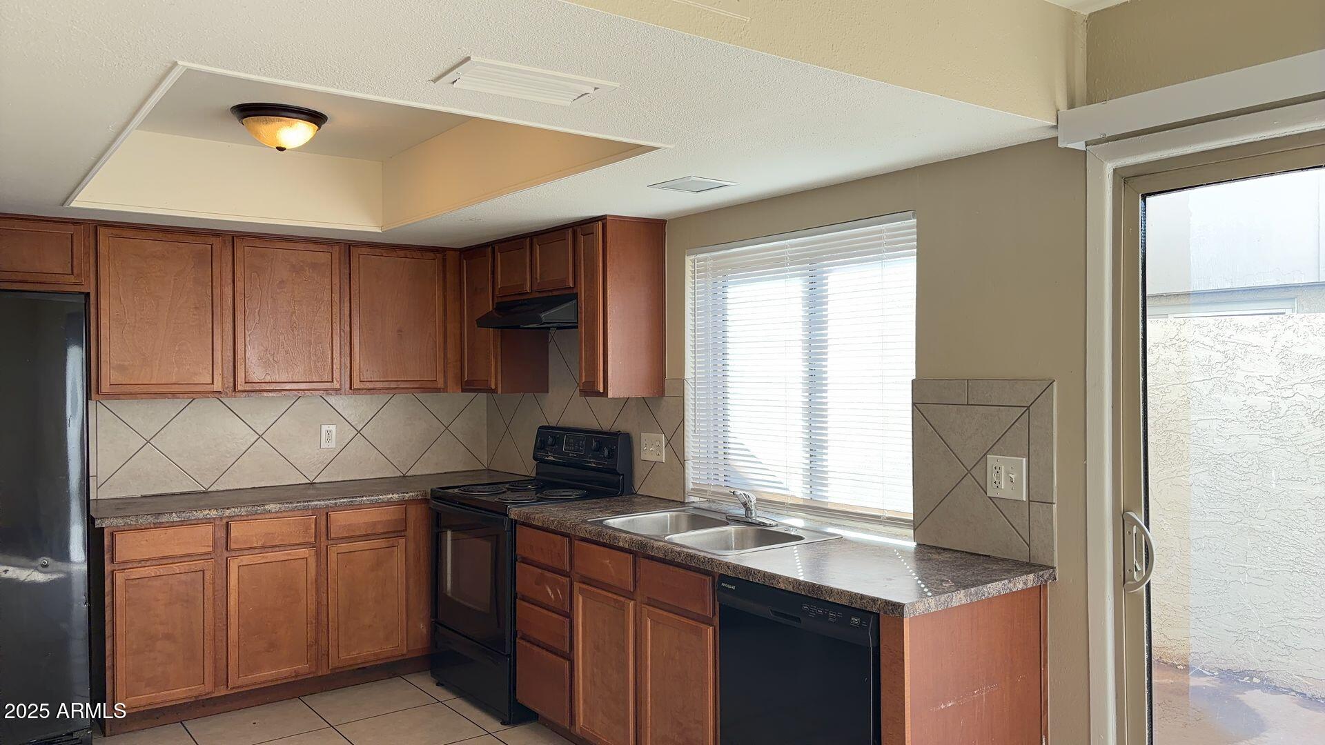 2415 West Greenway Road, Unit 3 Phoenix, AZ 85023 - Photo 10 of 36 a kitchen with granite countertop a sink and white cabinets