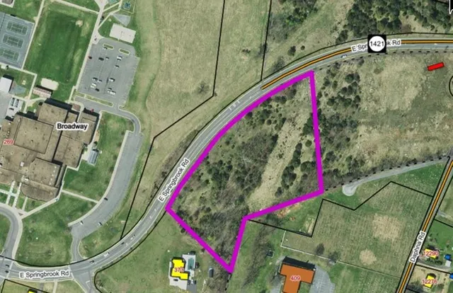 an aerial view of a house with a garden and swimming pool