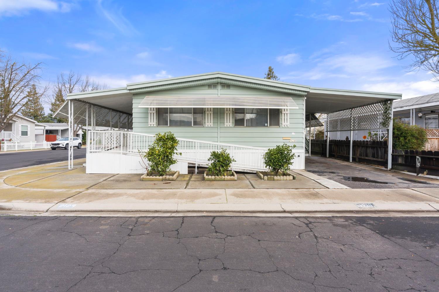 2129 Viking Lane Modesto, CA 95350 - Photo 1 of 1 a front view of a house with a garden and plants