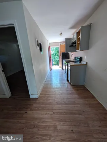 a view of an empty room and wooden floor