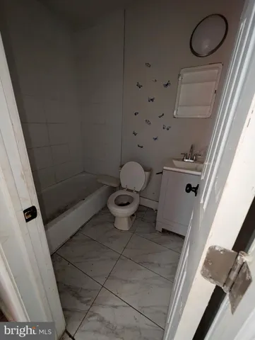 a view of a room with wooden floor and window