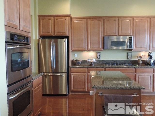 1065 Meridian Ranch Drive Reno, NV 89523 - Photo 14 of 25 a kitchen with granite countertop a refrigerator and a stove top oven