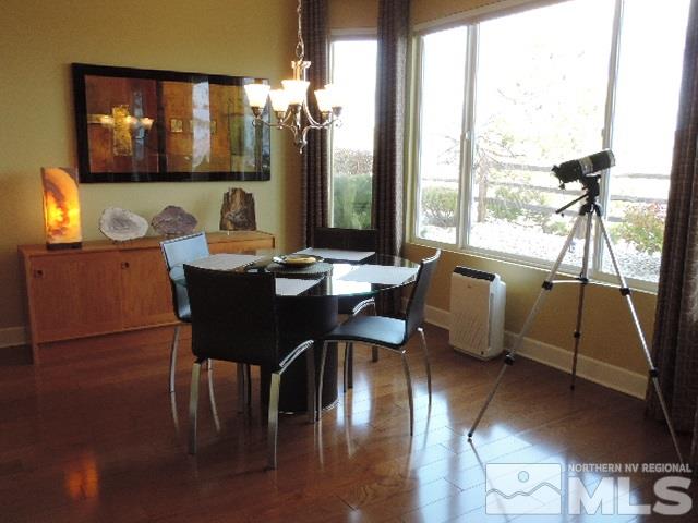 1065 Meridian Ranch Drive Reno, NV 89523 - Photo 15 of 25 a view of a dining room with furniture a chandelier and wooden floor