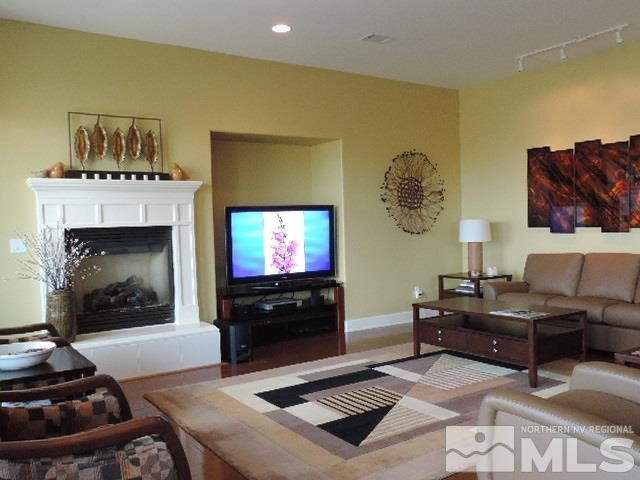 1065 Meridian Ranch Drive Reno, NV 89523 - Photo 16 of 25 a living room with furniture a flat screen tv and a fireplace