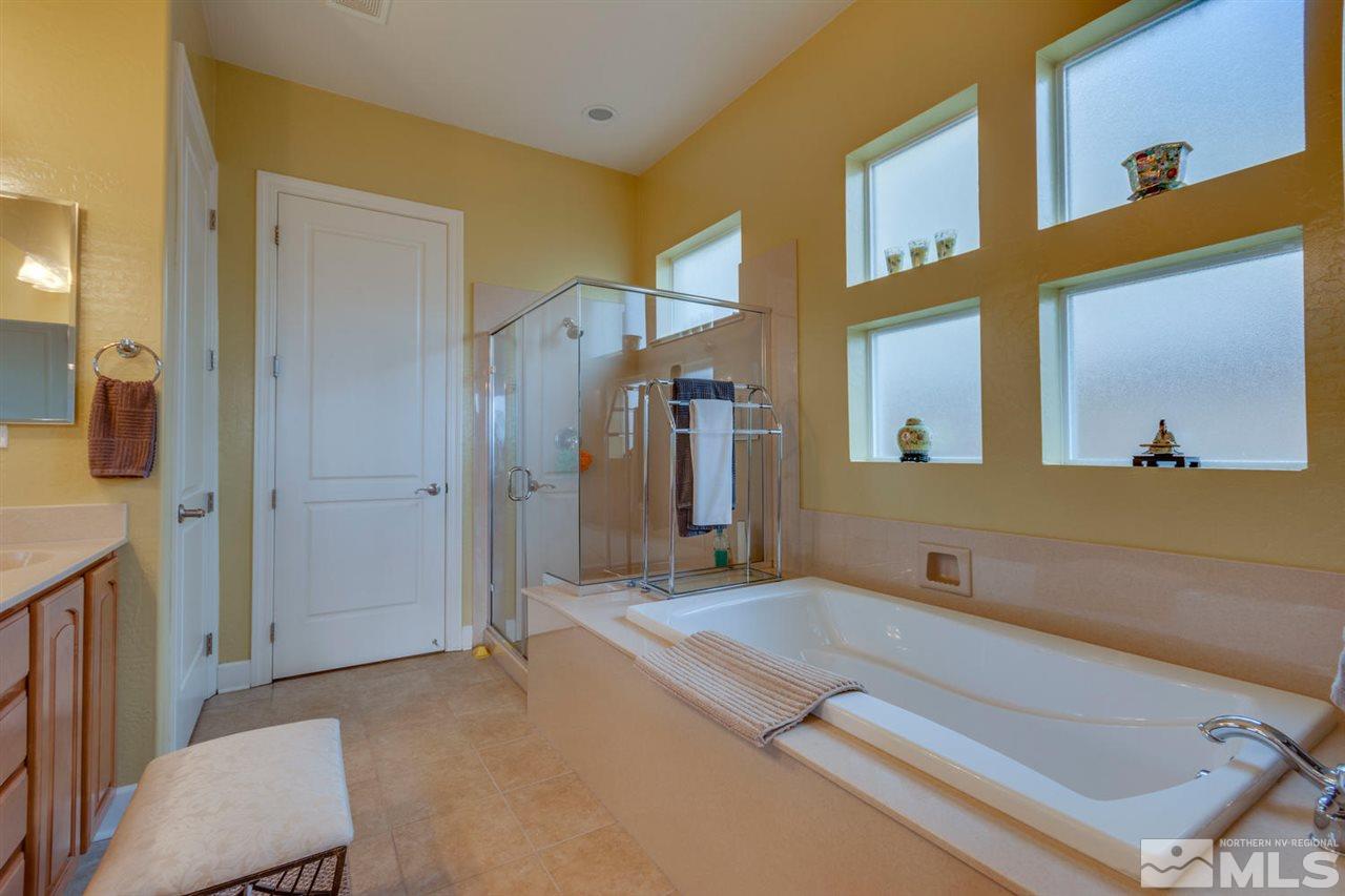 1065 Meridian Ranch Drive Reno, NV 89523 - Photo 20 of 25 a spacious bathroom with a granite countertop sink and a mirror