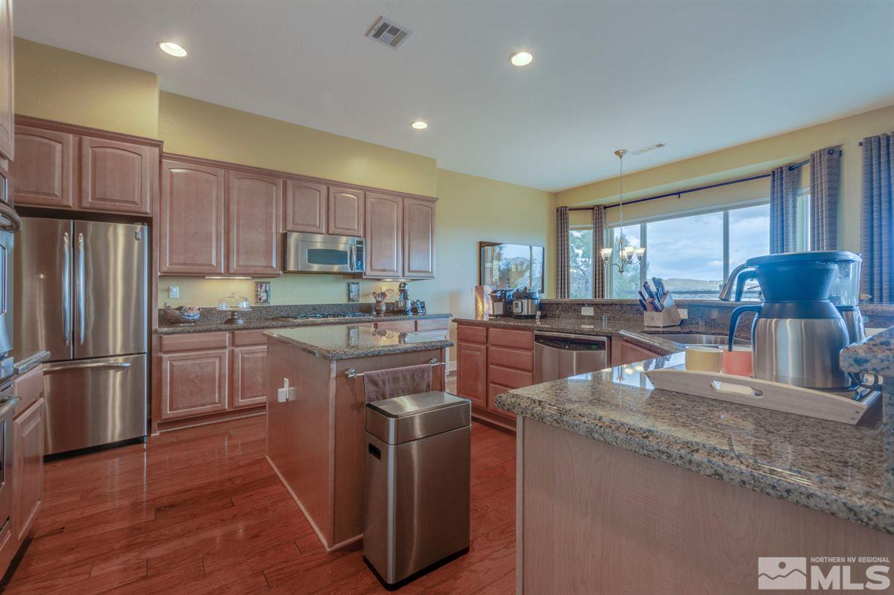1065 Meridian Ranch Drive Reno, NV 89523 - Photo 4 of 25 a kitchen with stainless steel appliances granite countertop a refrigerator a sink dishwasher a stove and a oven with wooden floor