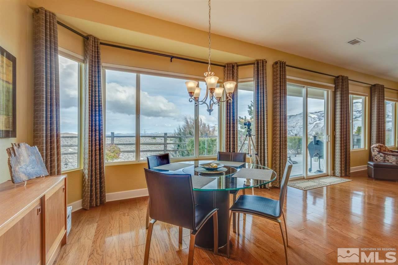 1065 Meridian Ranch Drive Reno, NV 89523 - Photo 5 of 25 a view of a dining room with furniture large windows and wooden floor