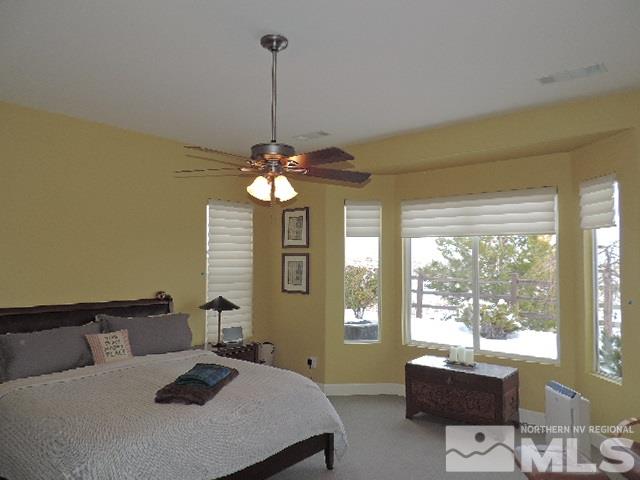 1065 Meridian Ranch Drive Reno, NV 89523 - Photo 10 of 25 a bedroom with a bed and a chandelier
