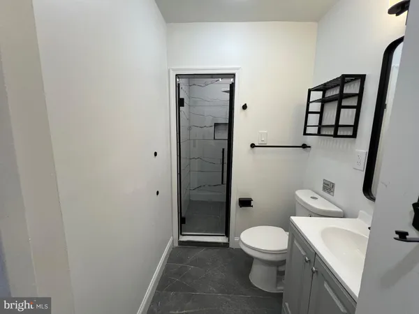 a bathroom with a toilet a sink and shower