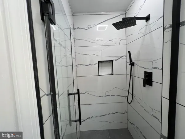 a bathroom with a shower and a glass door