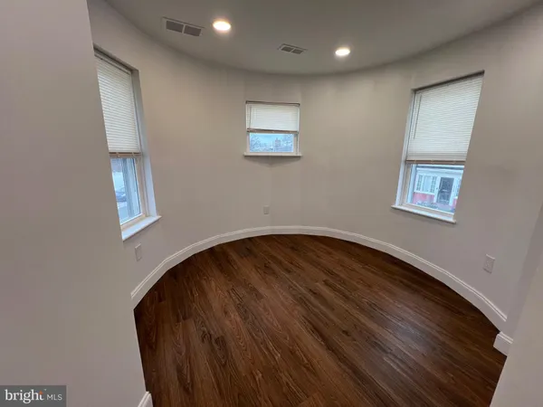 a view of wooden floor and windows in a room