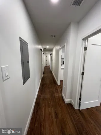 a view of a hallway with wooden floor