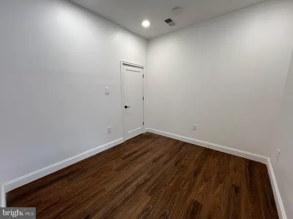 a view of room with wooden floor