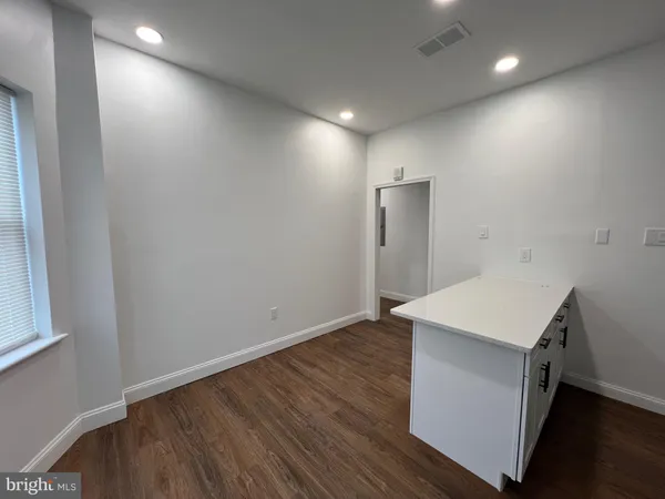 an empty room with wooden floor