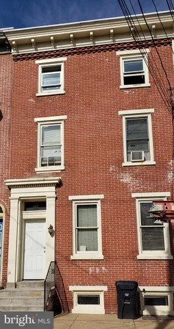 a brick building with a door and a window