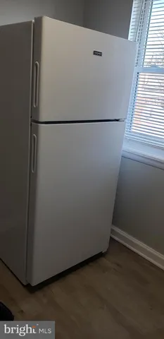 a white refrigerator freezer sitting in a kitchen
