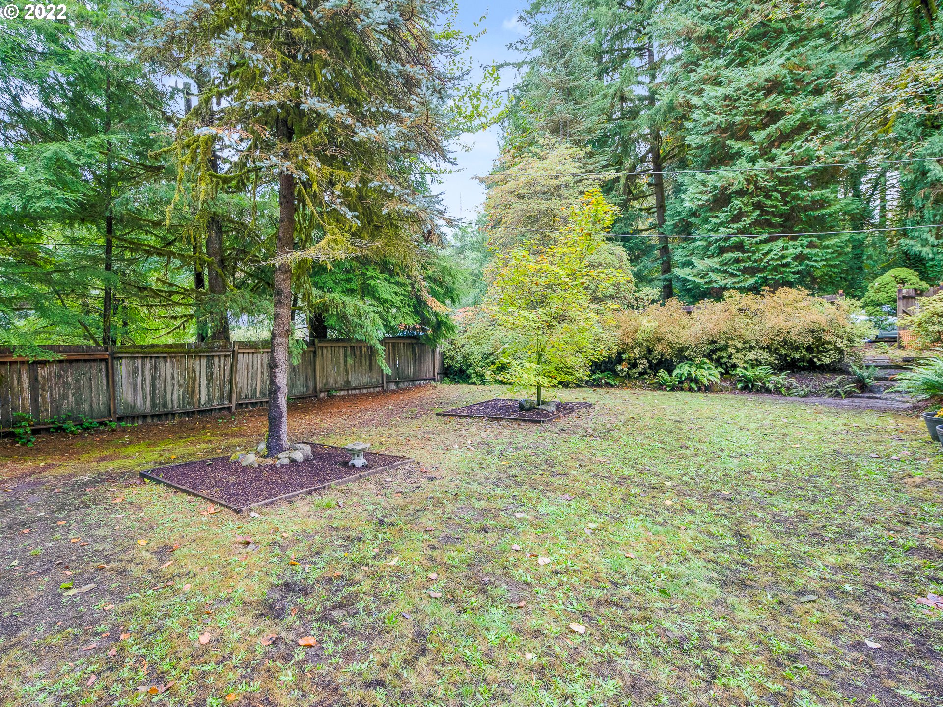 15910 Southeast Ten Eyck Road Sandy, OR 97055 - Photo 11 of 32 a backyard of a house with lots of plants and tree