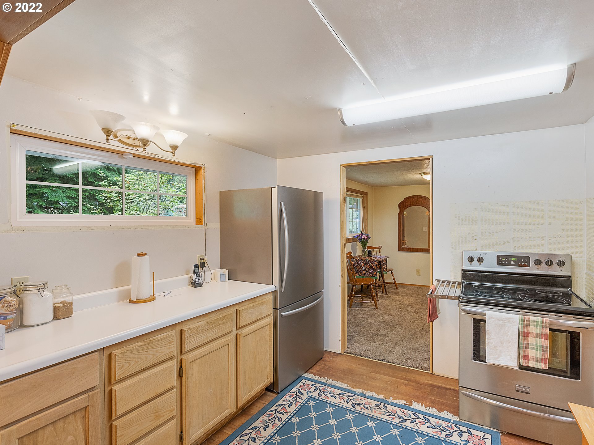 15910 Southeast Ten Eyck Road Sandy, OR 97055 - Photo 32 of 32 a kitchen with a refrigerator and a stove top oven