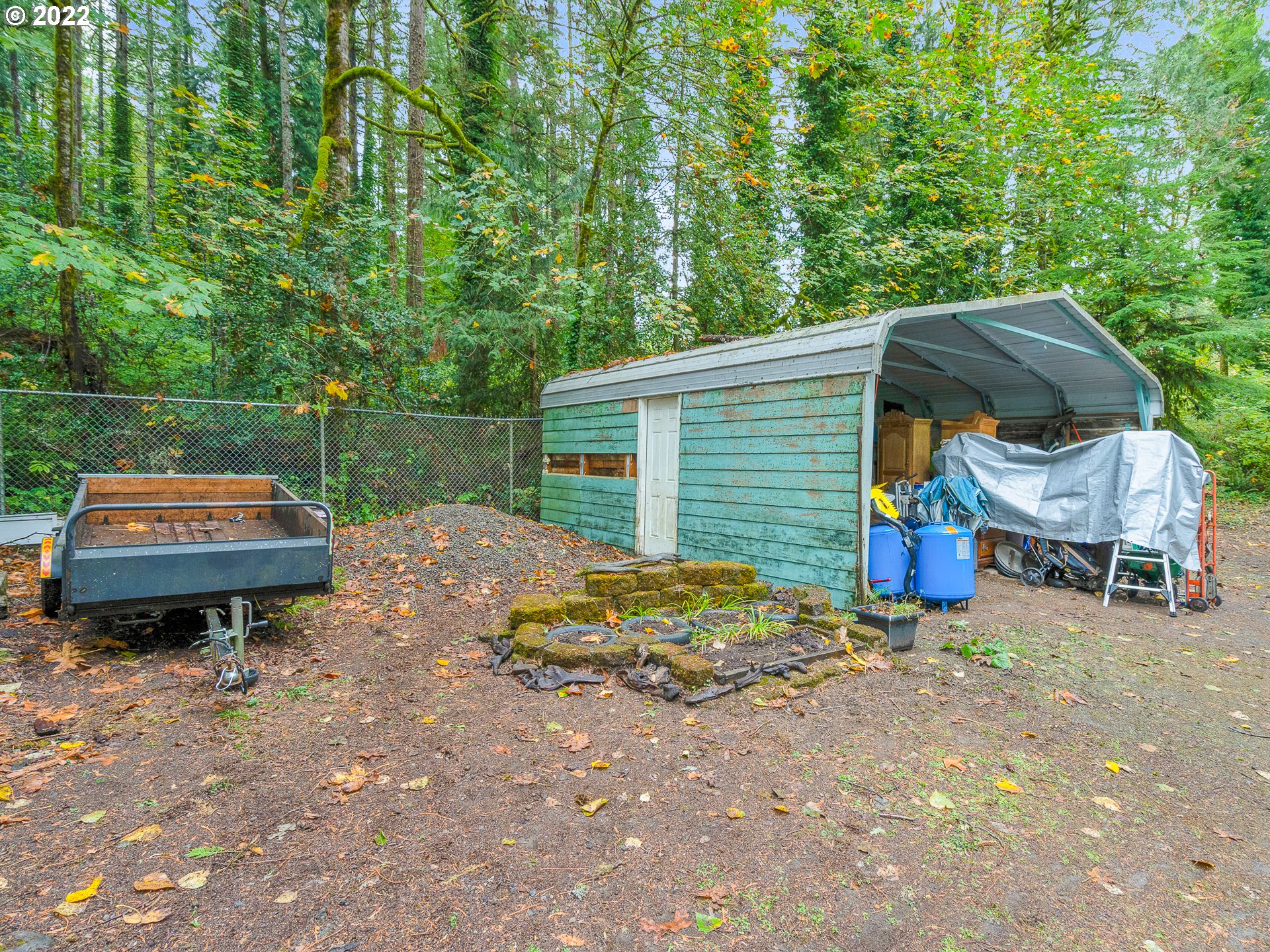 15910 Southeast Ten Eyck Road Sandy, OR 97055 - Photo 9 of 32 a backyard of a house with barbeque oven and outdoor seating