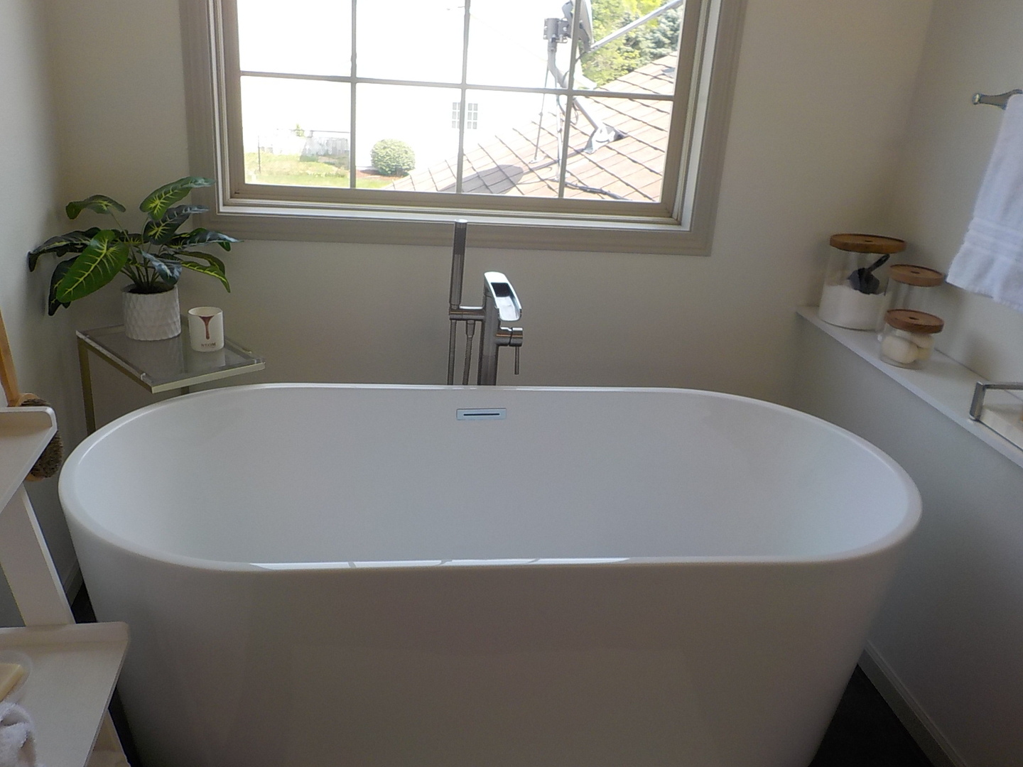 4412 Ridgeview Lane Byron, IL 61010 - Photo 25 of 35 a white tub sitting in a bathroom next to a window