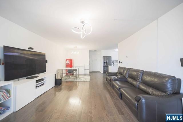 2100 Linwood Avenue, Unit 17T Fort Lee, NJ 07024 - Photo 4 of 17 a living room with furniture and a flat screen tv