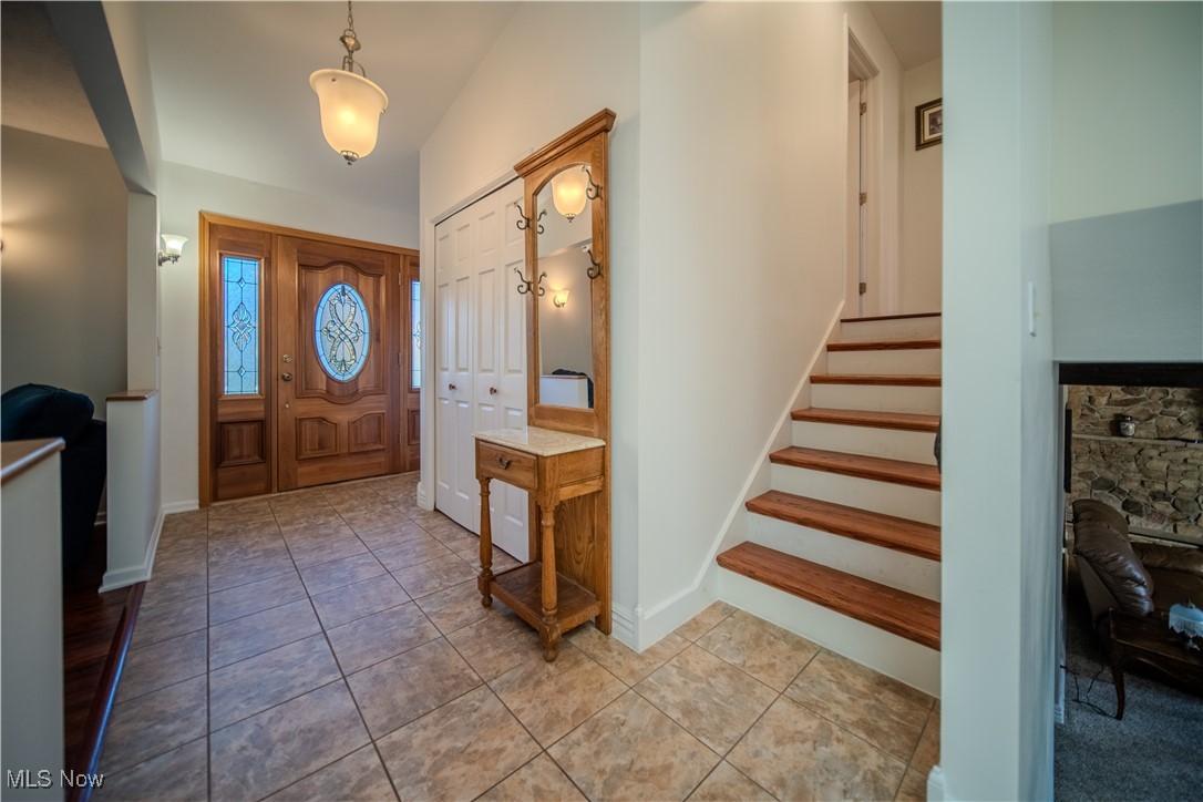 1394 Saxe Road Mogadore, OH 44260 - Photo 22 of 39 Entryway with stairs and light tile patterned flooring