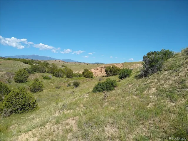 a view of a beach with sunset in background