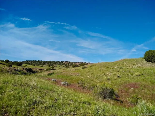 a view of a large mountain with mountains in the background