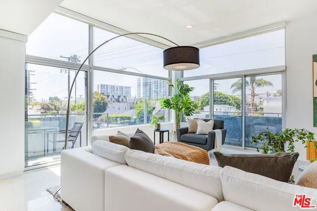 a table and chairs in front of a balcony