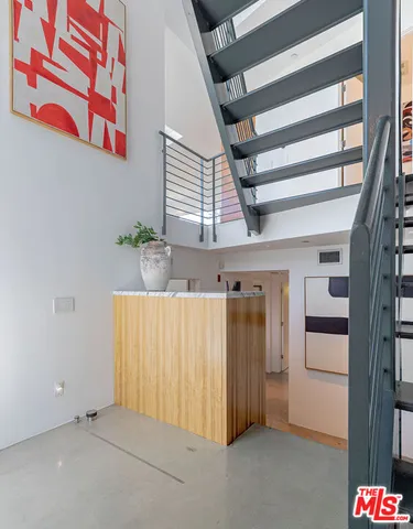 a bedroom with a bed and a chair