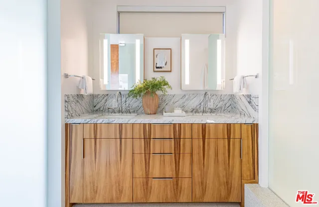 a bedroom with a large bed and a painting on the wall