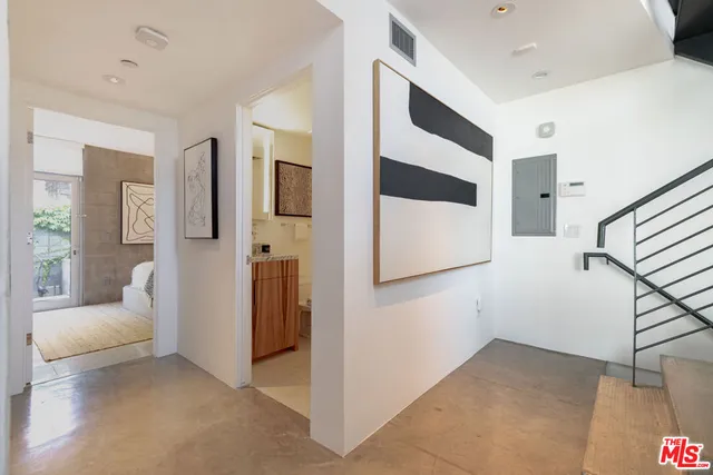 a balcony with chairs and a table