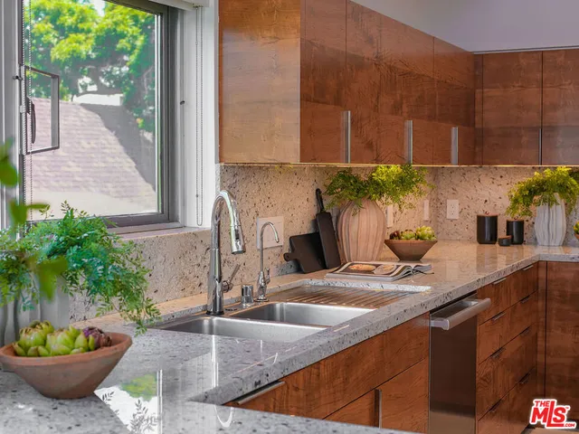 a kitchen with stainless steel appliances kitchen island granite countertop a sink and cabinets
