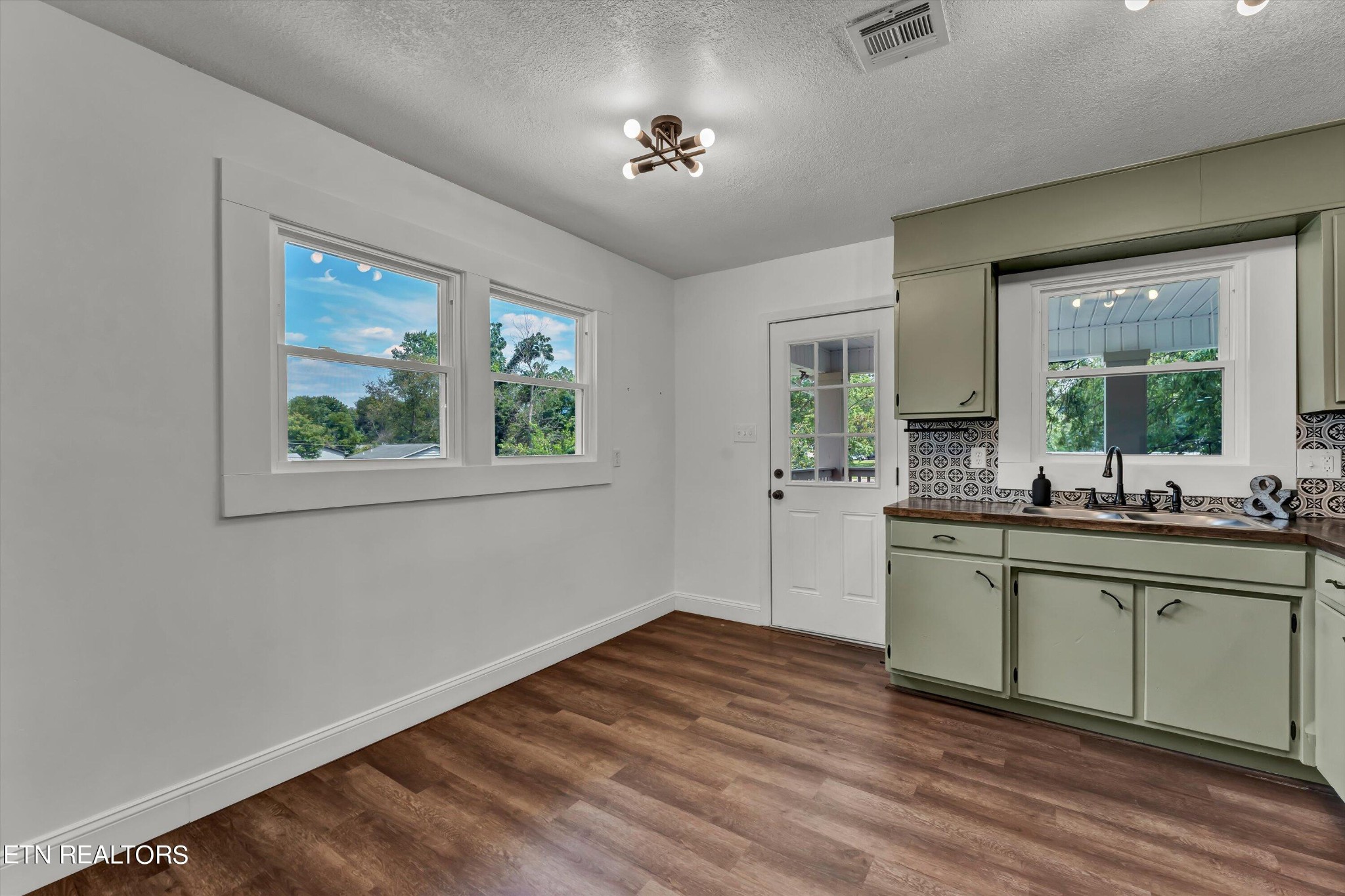 133 Londonderry Road Knoxville, TN 37923 - Photo 11 of 35 a kitchen with a wooden floor and window