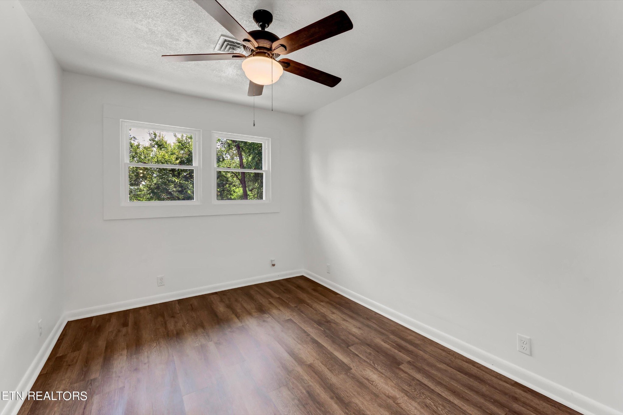 133 Londonderry Road Knoxville, TN 37923 - Photo 19 of 35 an empty room with wooden floor ceiling fan and window