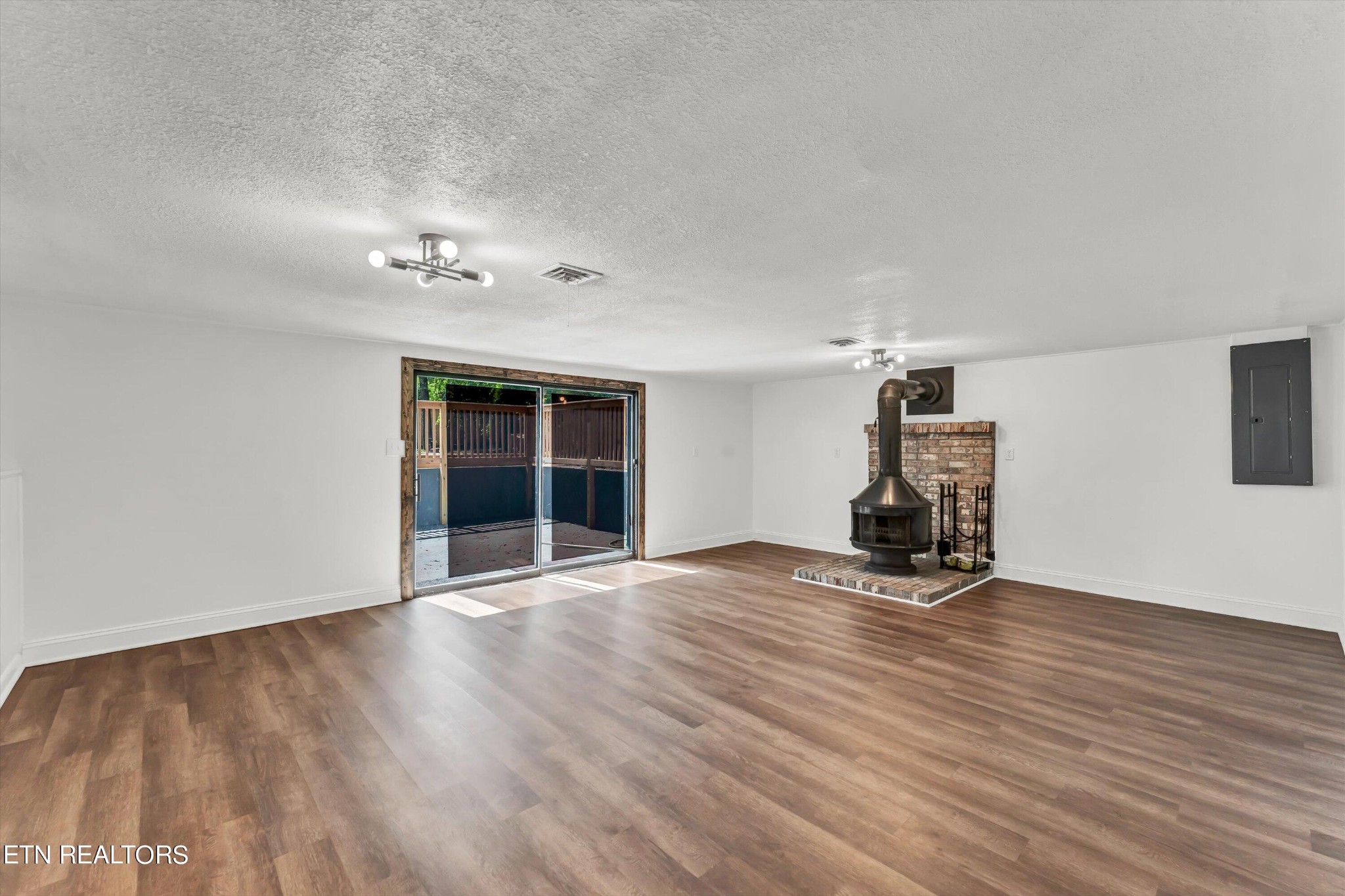 133 Londonderry Road Knoxville, TN 37923 - Photo 21 of 35 an empty room with wooden floor and windows