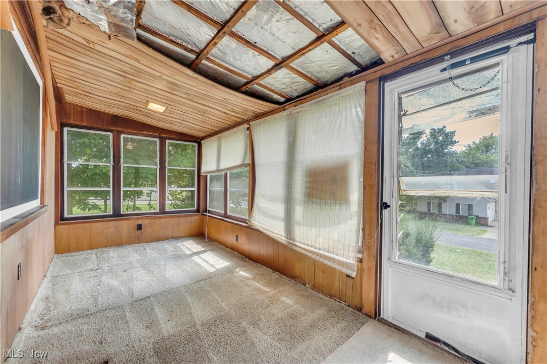 12931 Fruitside Road Garfield Heights, OH 44125 - Photo 8 of 15 Unfurnished sunroom with vaulted ceiling, plenty of natural light, and wood ceiling