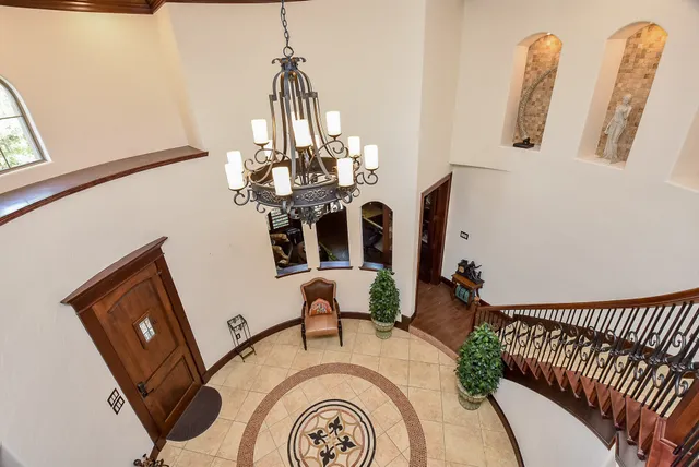 a view of a room with furniture and chandelier