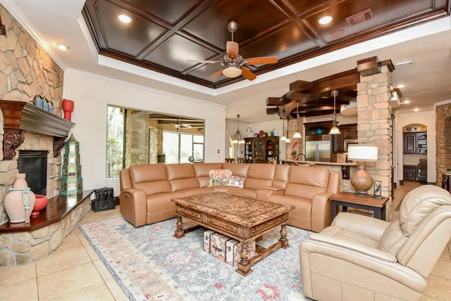 a living room with furniture a fireplace and a flat screen tv