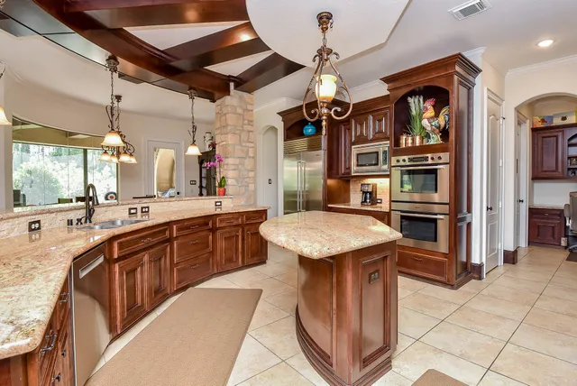a kitchen with stainless steel appliances granite countertop a sink and cabinets